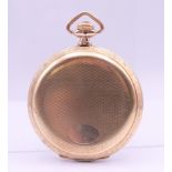 A gold plated full hunter pocket watch. 5 cm diameter.