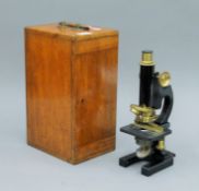 A monocular microscope by R&J Beck Ltd London, in mahogany case. The case 33 cm high.