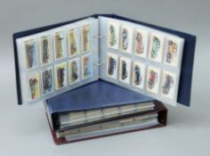 Three albums of cigarette cards.