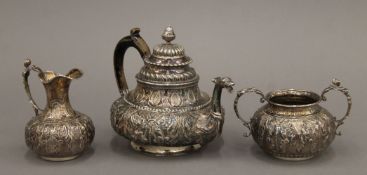 A Continental three-piece embossed silver tea set. The teapot 18 cm long. 616.