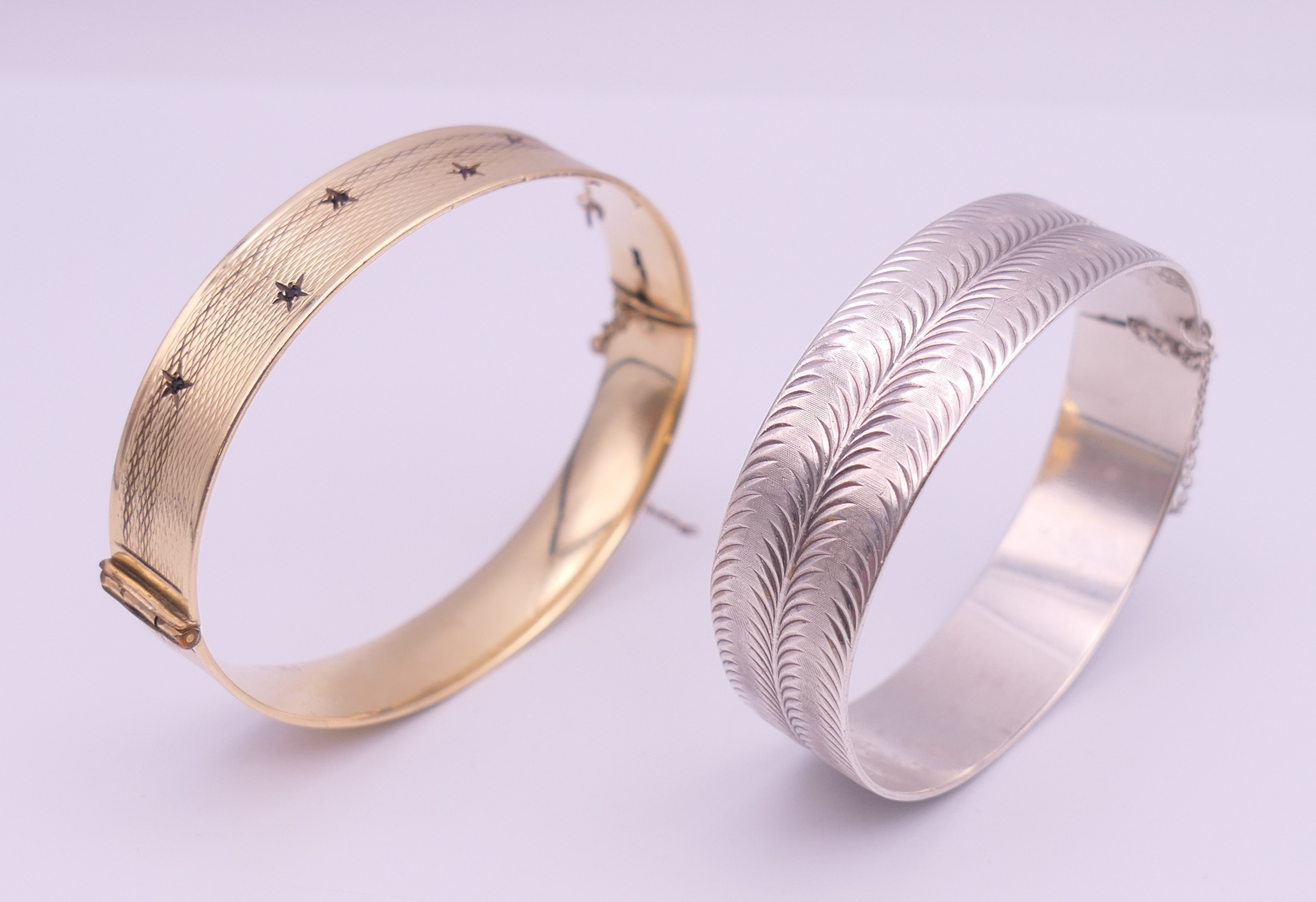 A silver bangle and another bangle. The former 6 cm diameter and 26.2 grammes.