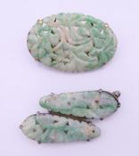 Two silver and jade brooches. The largest 4 cm wide.