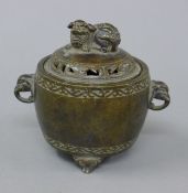 A Chinese bronze censer, the lid with dog-of-fo finial. 15.5 cm wide.