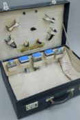 An early 20th century gentleman's travelling case partially fitted and with outer cover. 50.