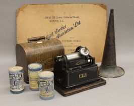 An Edison Gem phonograph and a collection of phonograph rolls. The former 28 cm long.