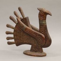 An Eastern carved wooden carving set formed as a bird. 33 cm high.