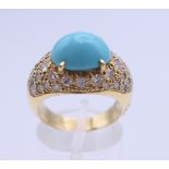 An 18 ct gold turquoise and diamond ring. Ring size N. 8.6 grammes total weight.