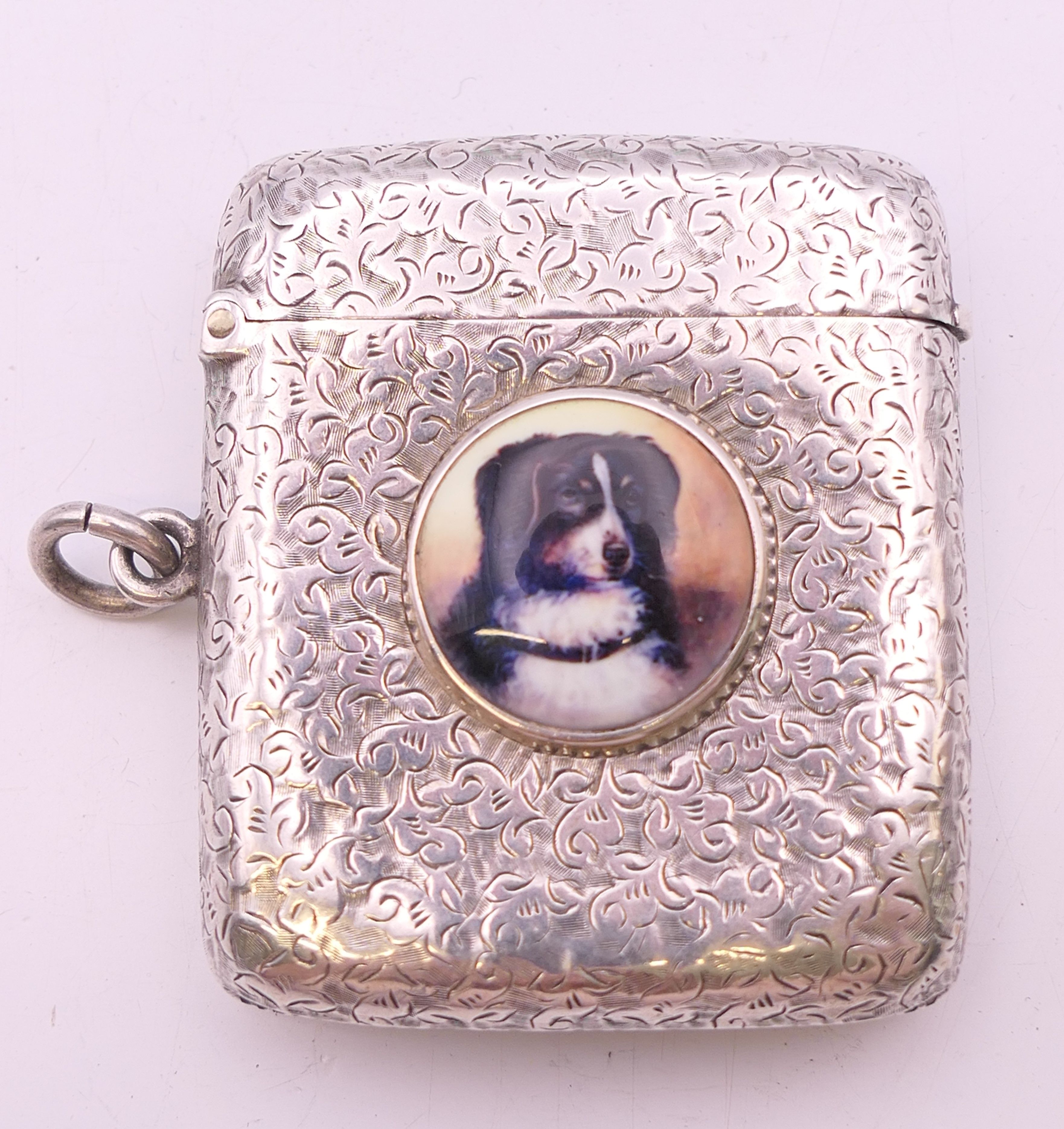 A Victorian silver vesta with leaf chased pattern and dog portrait roundel, Birmingham 1894.