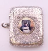 A Victorian silver vesta with leaf chased pattern and dog portrait roundel, Birmingham 1894.