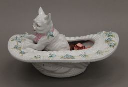 A Victorian porcelain model of a cat in a hat. 15 cm high.