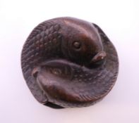 A bronze double fish. 4 cm diameter.