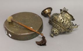 A brass gong and a brass hanging incense burner. The former 30.5 cm diameter.