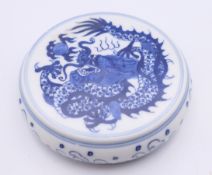 A Chinese porcelain round blue and white scroll weight. 9 cm diameter.