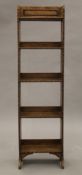 A slender early 20th century oak bookcase. 30 cm wide.