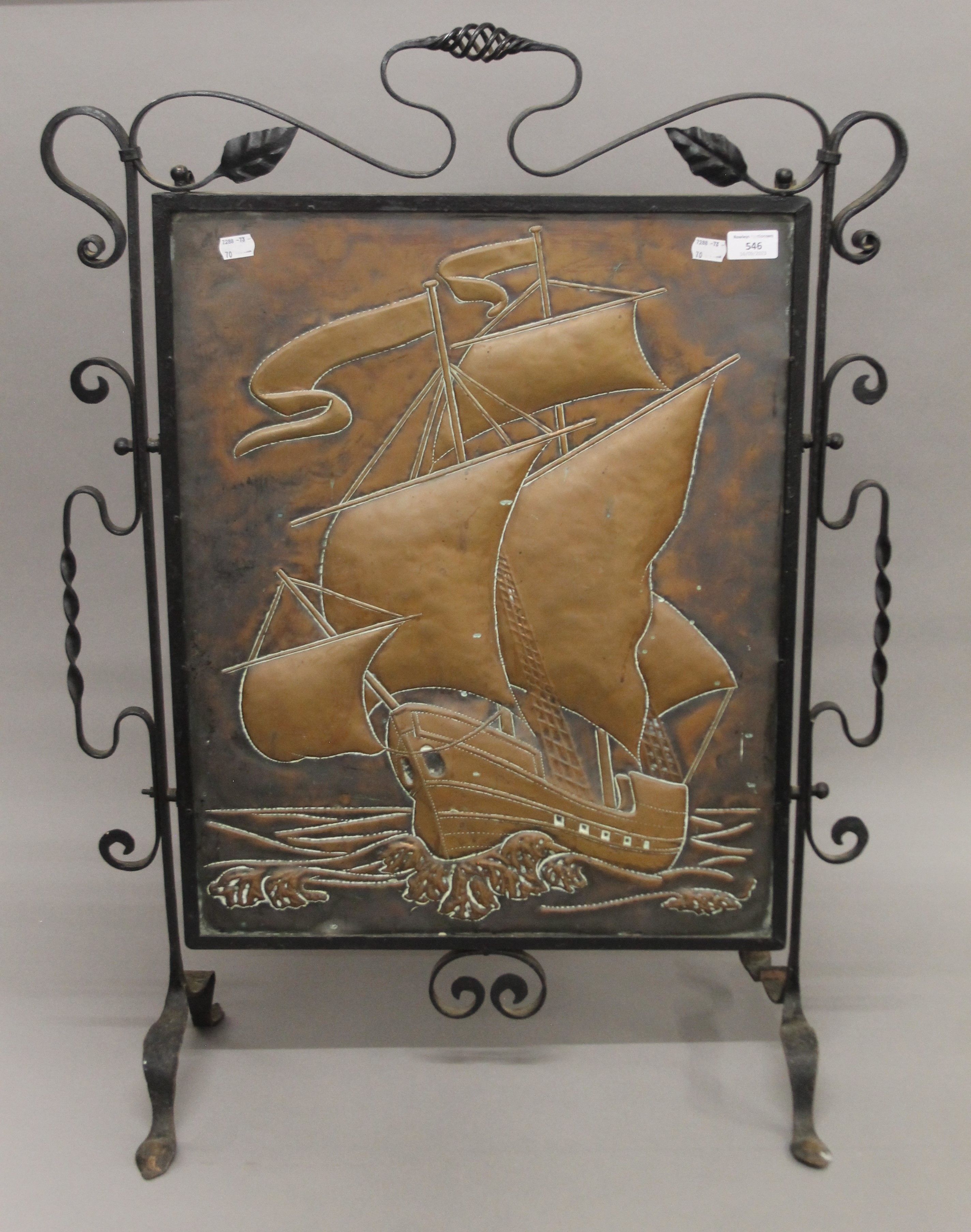 An Arts and Crafts copper and wrought iron fire screen depicting a galleon. 65 cm wide.