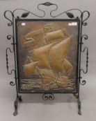 An Arts and Crafts copper and wrought iron fire screen depicting a galleon. 65 cm wide.