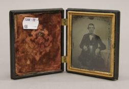 A Victorian cased photograph of a gentleman. 8.5 cm wide when closed.