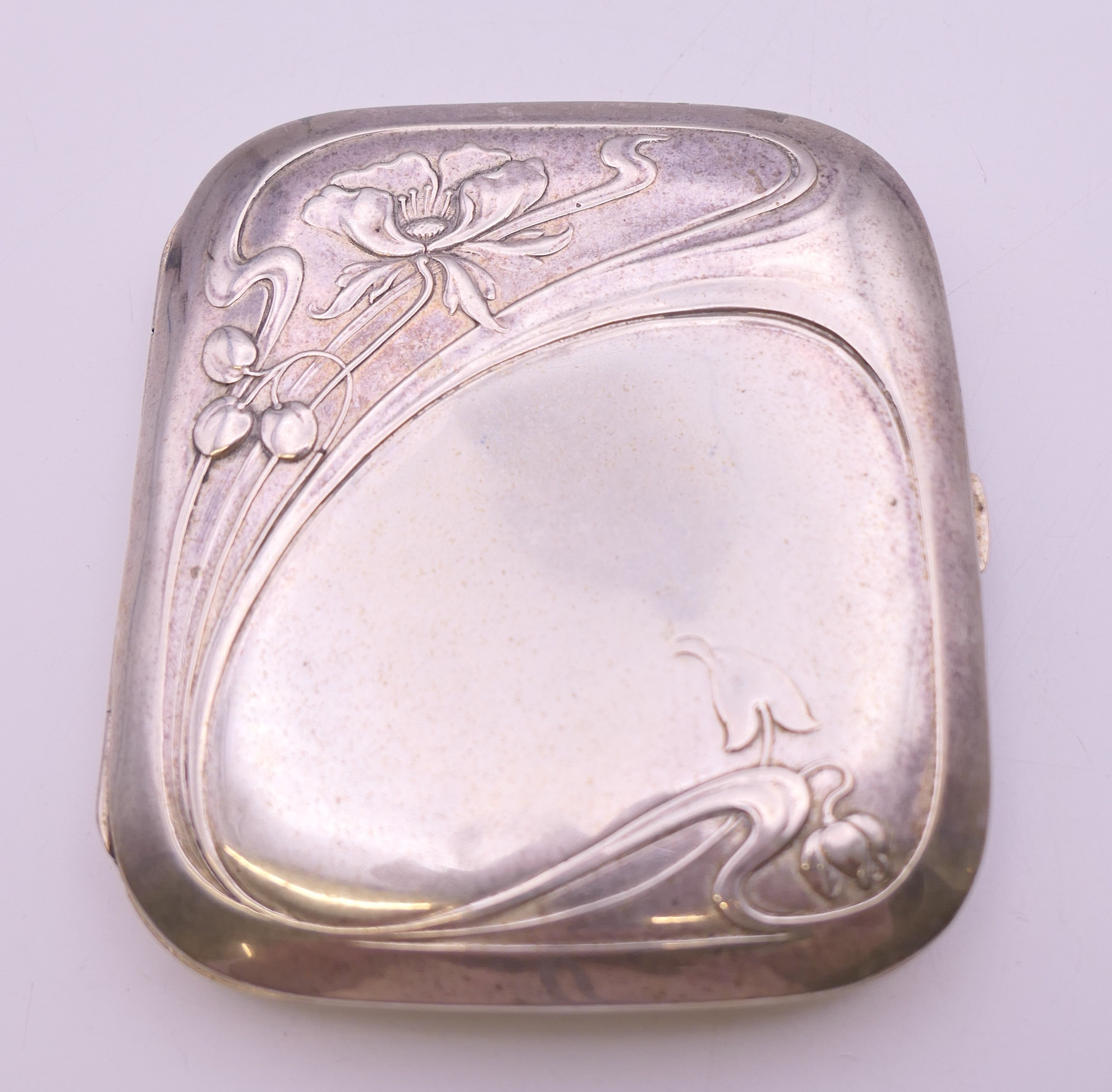An Art Nouveau 800 silver cigarette case. 8 cm wide. 78.6 grammes total weight.