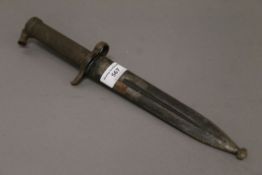 A bayonet in scabbard. 34.5 cm long.
