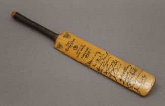 A 1956 England facsimile signed miniature cricket bat. 29.5 cm long.