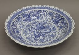 A Chinese blue and white porcelain bowl decorated with dragons. 40 cm diameter.