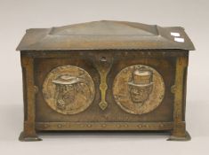 An Arts and Crafts beaten copper casket decorated with roundels depicting various Dickins