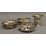 A silver plated chamberstick, a pair of plated coasters and a vase.