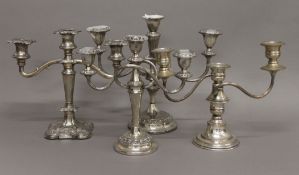 Four plated candelabra. The largest 28 cm high.