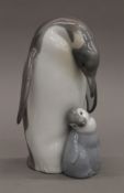 A Lladro penguin group. 18 cm high.