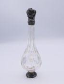 A silver top scent bottle. 12.5 cm high.