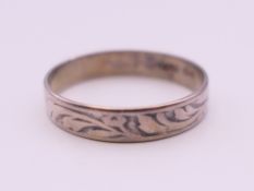 A silver engraved ring. Ring size R/S.