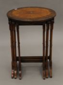 An early 20th century walnut nest of three tables. The largest 45 cm diameter.