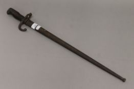 A bayonet in metal scabbard. 65.5 cm long.