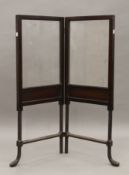 An Edwardian glazed panelled mahogany folding fire screen. 39 cm wide closed.