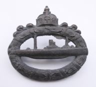 A military badge, 4.75 cm wide.