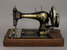 A boxed Singer sewing machine. 44 cm long.