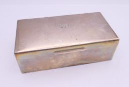 A silver cigarette box, hallmarked Birmingham 1964. 16.5 cm wide.
