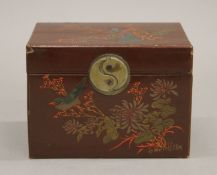 A chinoiserie lacquered tea caddy. 13.5 cm wide.