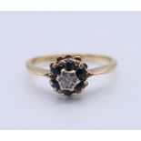 An 18 ct gold sapphire and diamond ring. Ring size K. 2.3 grammes total weight.