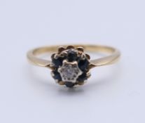 An 18 ct gold sapphire and diamond ring. Ring size K. 2.3 grammes total weight.