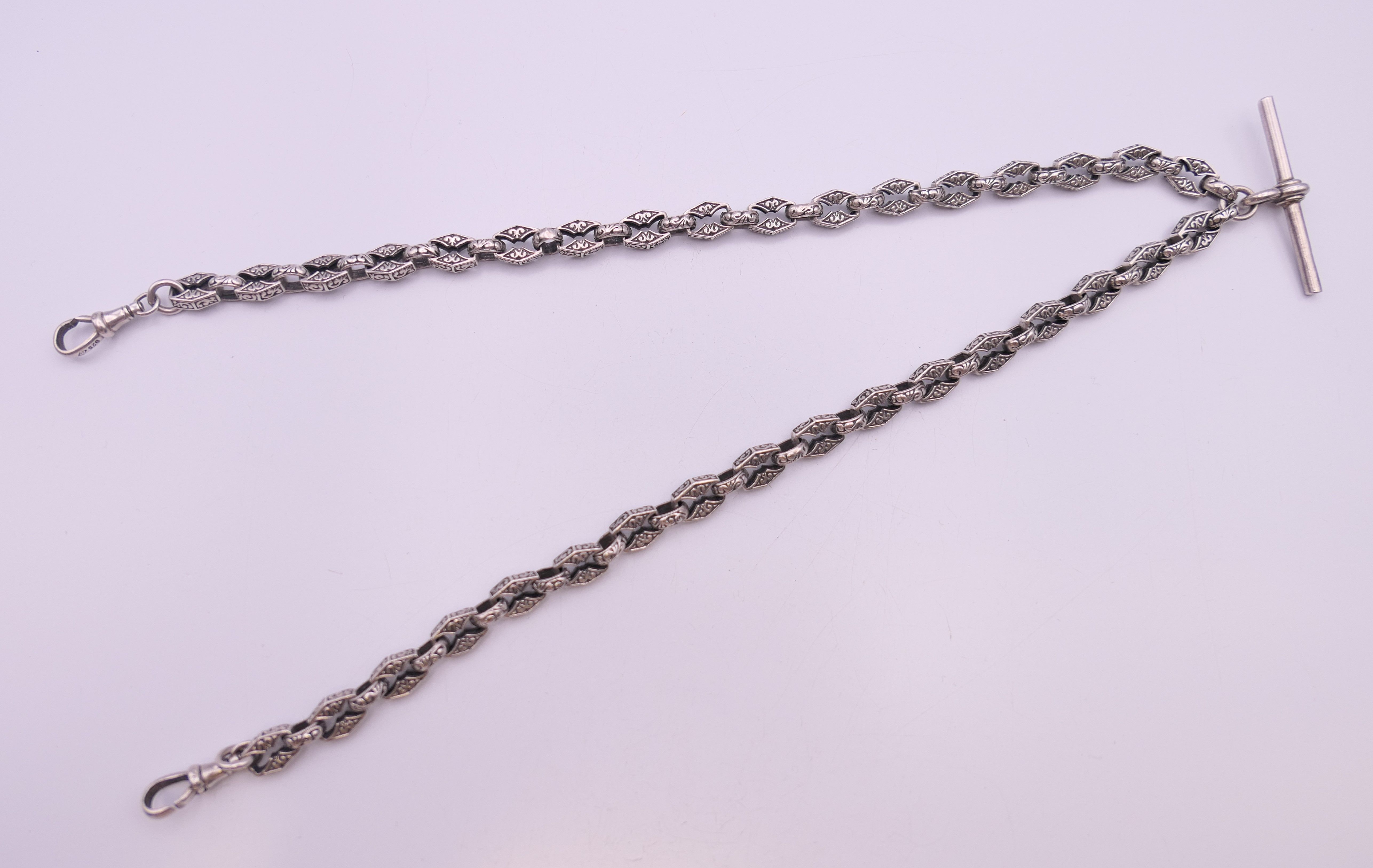 A silver watch chain with patterned links. 49 cm long. 49.1 grammes. - Image 2 of 7