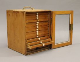 A 19th century pine collectors cabinet containing microscope slides. 24.5 cm high.