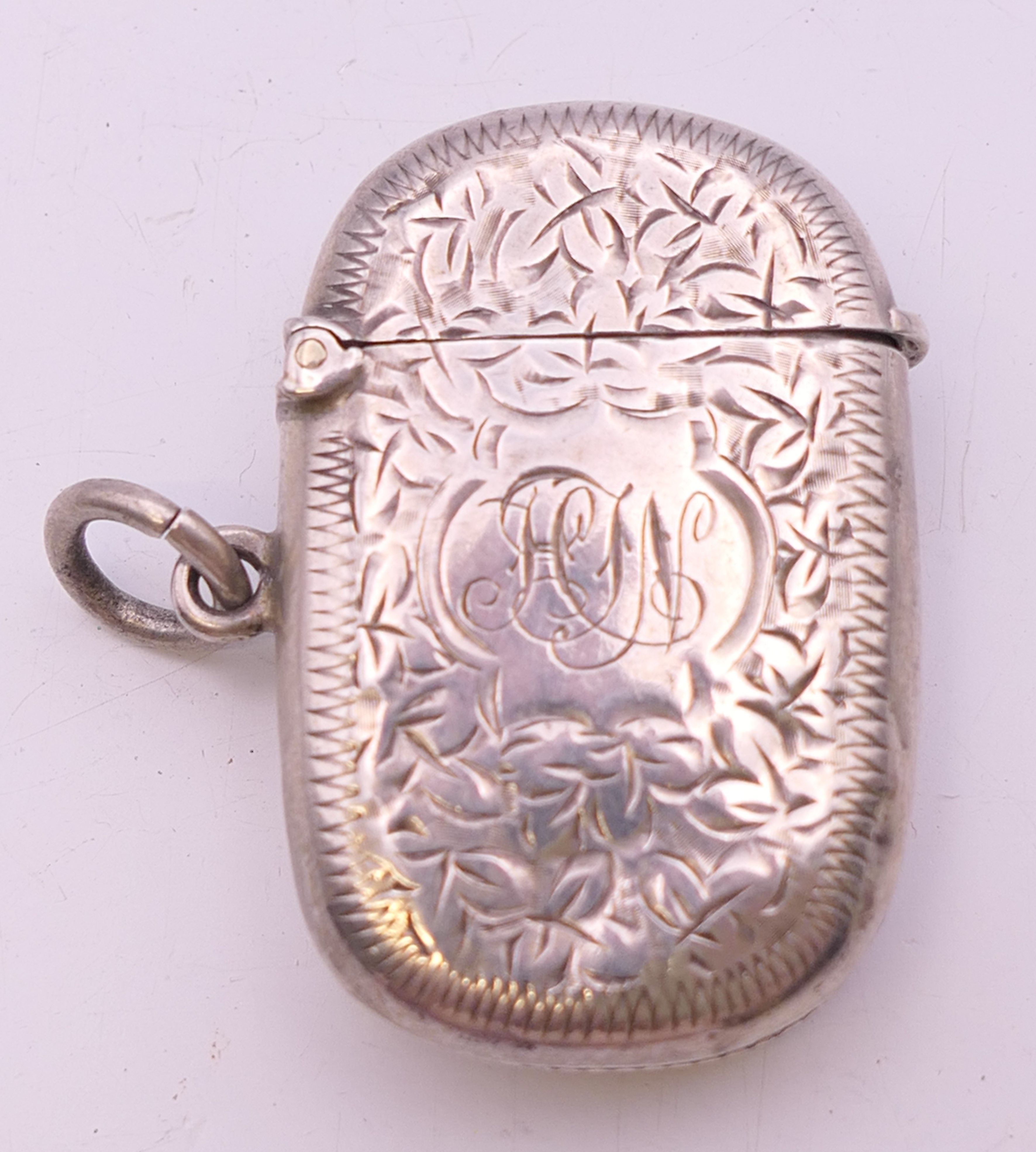 A Victorian silver vesta with leaf chased pattern, Birmingham 1898. 4 cm wide. 14.8 grammes.