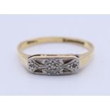 An 18 ct gold, platinum and diamond ring. Ring size M/N. 2.1 grammes total weight.