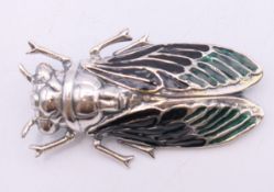 A silver beetle form brooch. 5 cm long.