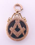 A Freemasons 9 ct gold fob locket. 3 cm high. 5.4 grammes total weight.