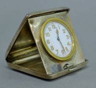A silver cased travelling clock, hallmarked London 1904,
