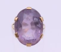 A 9 ct gold amethyst set ring. Ring size L/M. 7.6 grammes total weight.