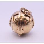A 9 ct gold and silver Masonic ball pendant, opening into a cross. 2 cm high closed. 12.