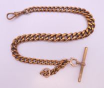 A gold plated curb link watch chain with T-bar. 31 cm long.